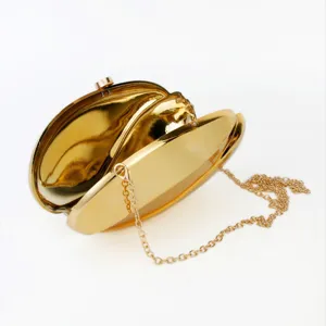 Golden metallic acrylic evening clutch bag, trendy wavy crossbody shoulder bag for women.