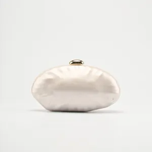 Acrylic evening clutch bag detail showing glossy pearl finish and gold clasp for women wedding.