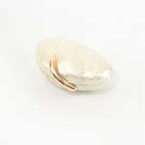 Detailed view of the elegant oval acrylic evening clutch featuring a luxury gold leaf clasp design.