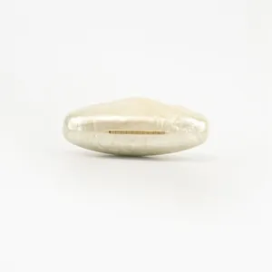 Close-up of elegant white pearlized acrylic evening clutch bag with gold hinge detail.