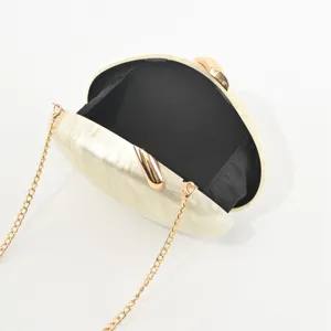 Elegant oval acrylic evening clutch bag with gold chain shoulder strap for women.