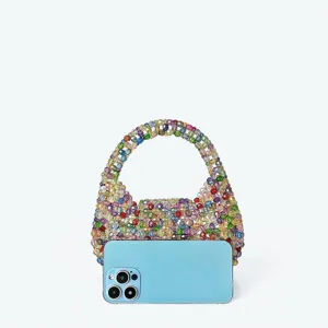 Detailed view of colorful handmade crystal beaded mini handbag, sparkling transparent texture.