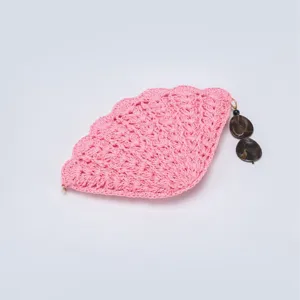 Pink crochet shell bag detail view showing delicate hollow fan weave and charm pendant.