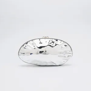 Silver metallic ovoid evening clutch bag detail, glossy acrylic minaudiere wedding purse.