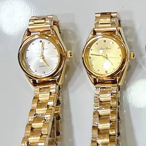 Women vintage quartz watch with metal link strap, simple retro style elegant wristwatch.