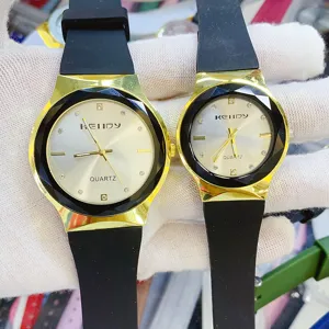 Minimalist couple quartz watch with silicone strap and faceted gold bezel for daily use.