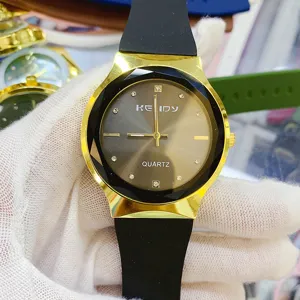 Minimalist quartz watch with faceted bezel, black silicone strap, and elegant dial design.