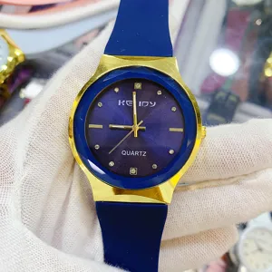 Minimalist quartz couple watch with blue silicone strap and gold bezel for daily wear.
