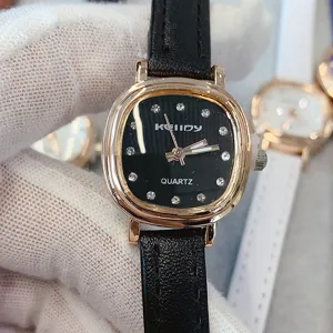 Montre quartz femme cadran noir, index strass, boîtier or rose et bracelet cuir noir élégant.
