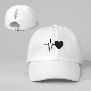 White ponytail baseball cap featuring a cute black heart rate and heart graphic print.