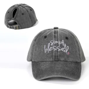 Close up view of washed grey ponytail baseball cap featuring embroidered simply blessed text.