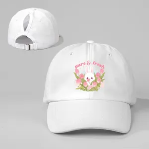 Detailed view of white ponytail baseball cap featuring cute rabbit tulip print and buckle.