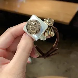 Cute bear hair tie with white square resin and retro coin pendant for daily hair styling.