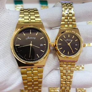 Classic couple quartz watch set with stainless steel strap, black dial, and date display.