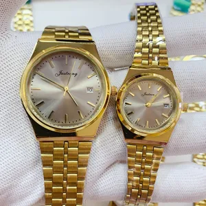 JUSTRONG gold couple quartz watch set featuring elegant metallic strap and clear calendar display.