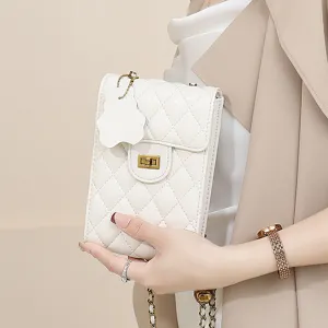 White quilted mini leather phone bag with chain strap, classic style detail shot.
