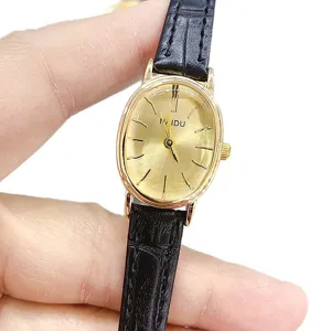 NAIDU minimalist oval quartz women's watch with black leather strap and gold tone case.