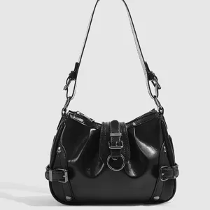 Detailed view of black gloss leather motorcycle shoulder bag with buckle and ring hardware.