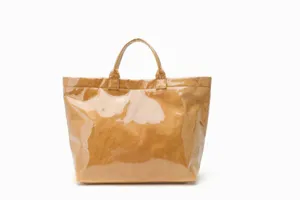 Clear detail shot of a brown waterproof transparent tote bag with dual handles and spacious interior.