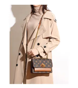 Chic retro monogram shoulder bag with elegant camellia lock and chain strap for women.
