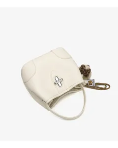 Minimalist white leather bucket bag with turn-lock closure and cute plush charm detail.
