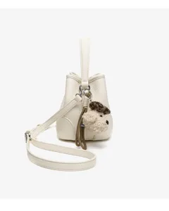 White leather bucket bag featuring a cute puppy charm, top handle and adjustable shoulder strap.