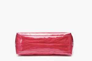 Detailed view of the bottom base of a pink glossy waterproof DuPont paper tote bag.