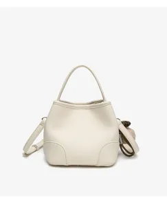 Minimalist white leather bucket bag detail showcase with top handle and adjustable shoulder strap.