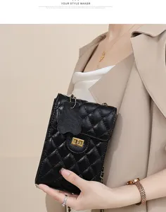Detailed view of the black quilted leather mini chain phone bag with chic clasp and strap.