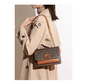 Luxury printed shoulder bag with chic chain strap and elegant flower lock for modern women.