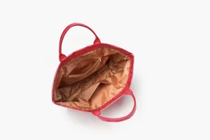 Red glossy waterproof tote bag interior detail with multiple storage pockets and zipper