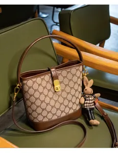 Fashion monogram bucket bag with top handle, shoulder strap and cute rabbit pendant.
