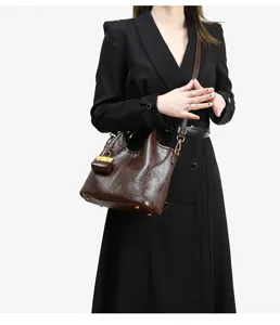 Genuine leather bucket bag shoulder messenger bag with padlock charm, stylish casual design.