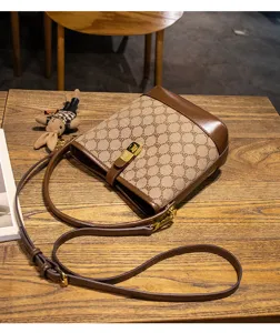 Stylish monogram bucket bag with leather trim, elegant shoulder bag for women use.