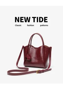 Detailed view of the dark red leather women handbag, featuring elegant bucket design and strap.