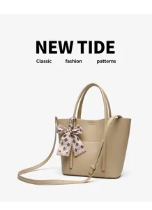 Detailed view of the beige leather tote bag with elegant plaid ribbon bow and strap.