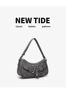 Detail view of vintage punk motorcycle hobo bag, featuring dual buckle straps and metal rings.