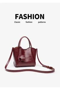 Burgundy leather handbag for women, stylish tote and crossbody bag with chic design and strap.