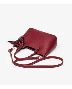 Burgundy leather women shoulder bag detail, elegant tote with polka dot scarf accessory.