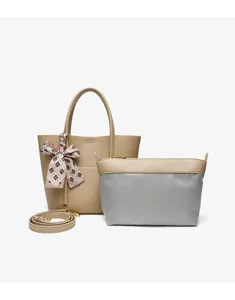 Detailed view of women's stylish leather tote bag with elegant bow scarf and crossbody strap.