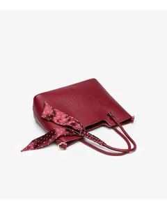 Elegant burgundy leather shoulder bag detail with chic polka dot silk scarf handle accent.