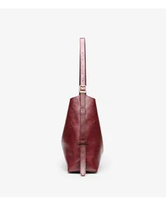 Detail view of the elegant wine red leather tote bag showing vertical strap and metal buckle.