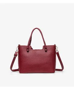 Detail shot of the dark red leather handbag showcasing texture and hardware details.