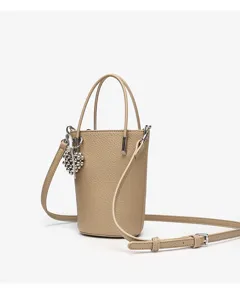 Mini leather bucket bag with metal charm and adjustable crossbody strap for women stylish daily use