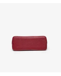 Red leather handbag bottom detail shot showcasing pebble texture and fine stitching quality.