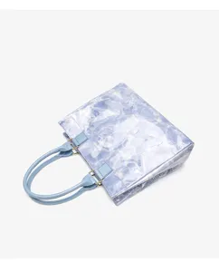 Close-up detail of the water ripple pattern and handle connection of the casual tote bag.