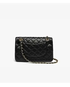 Detailed close-up view of the black quilted leather shoulder bag featuring gold chain strap.