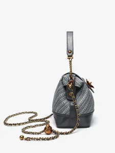 Woven camellia shoulder bag for women, stylish crossbody shell bag with chain strap.