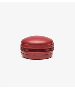 Detailed view of the small round leather bag zipper closure red texture elegant design.