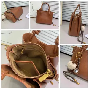Detailed view of brown leather handbag interior lining and hardware accents with chic knot handle design.